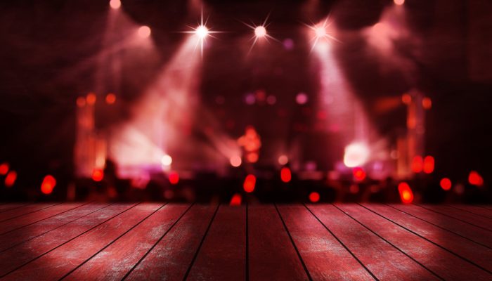 blurred concert lighting and bokeh on stage with wooden floor